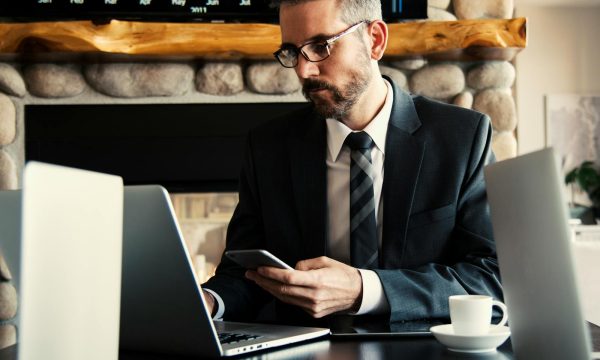 Man in Black Holding Phone